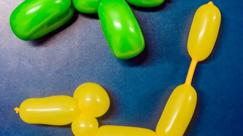 two yellow and green dog balloons